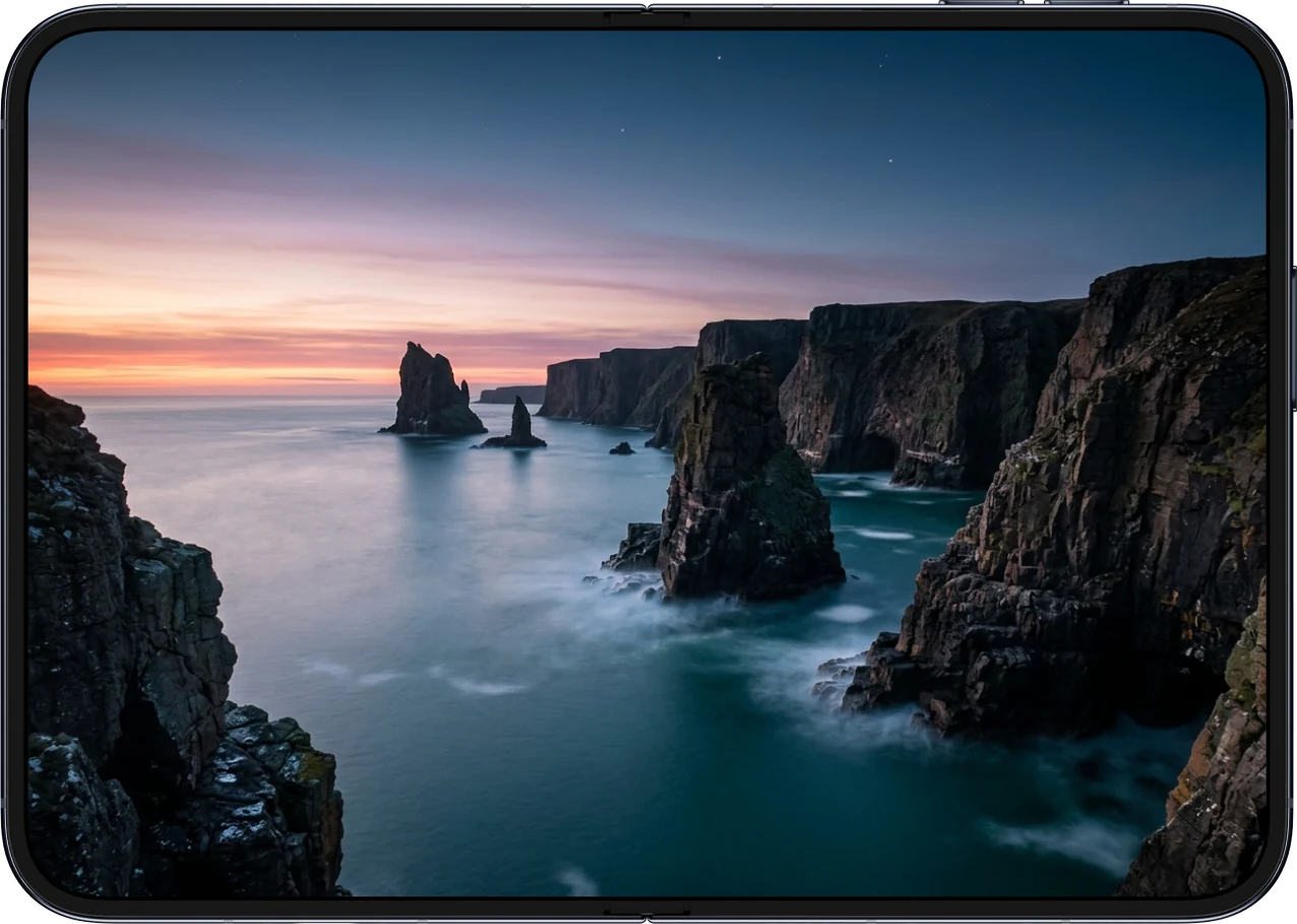 Sea stacks wallpaper on the inner screen of an open iPhone Duo
